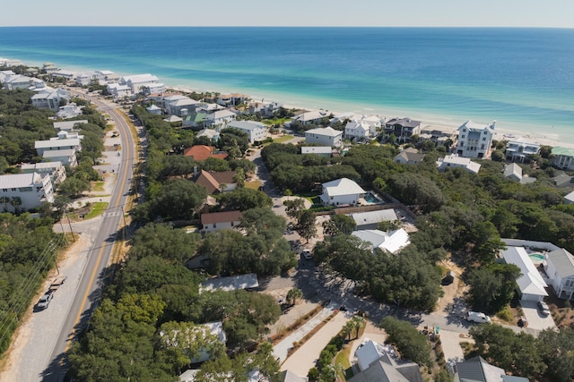 drone / aerial view featuring a water view and a view of the beach