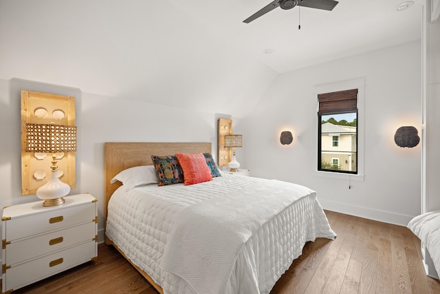 bedroom with ceiling fan, lofted ceiling, and hardwood / wood-style flooring