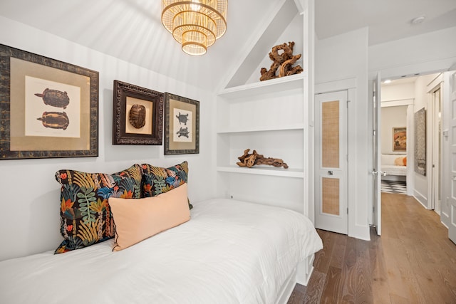 bedroom with hardwood / wood-style flooring and lofted ceiling