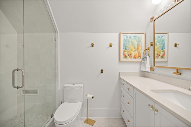 bathroom featuring vanity, toilet, and a shower with shower door