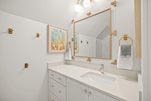 bathroom featuring vanity and vaulted ceiling