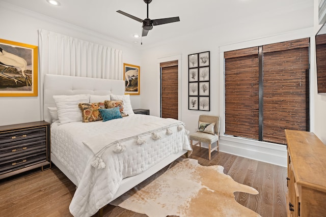 bedroom with hardwood / wood-style floors, ceiling fan, and ornamental molding