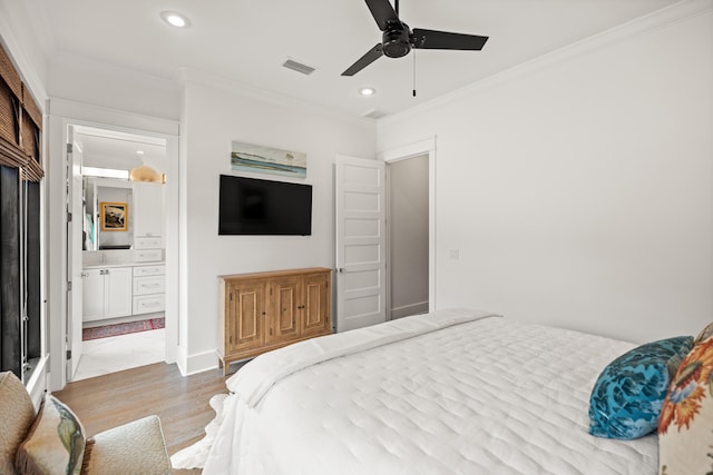 bedroom featuring hardwood / wood-style flooring, ceiling fan, ornamental molding, and ensuite bathroom