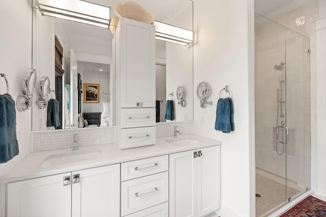 bathroom featuring backsplash, vanity, an enclosed shower, and crown molding