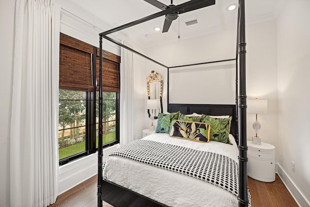 bedroom featuring ceiling fan, wood-type flooring, and ornamental molding