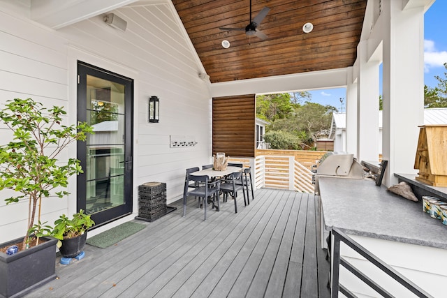 wooden terrace with grilling area and ceiling fan