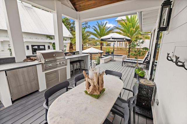 view of patio / terrace with a gazebo, a grill, exterior bar, and a wooden deck