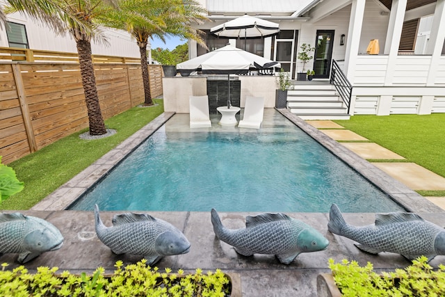 view of swimming pool with exterior kitchen