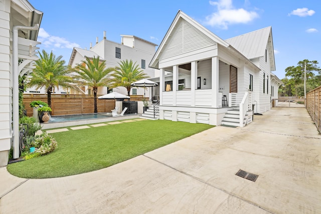 view of front of home with a front yard, a gazebo, and a patio