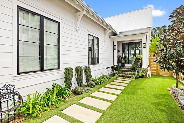 property entrance with a yard