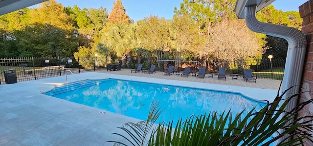 pool featuring fence and a patio