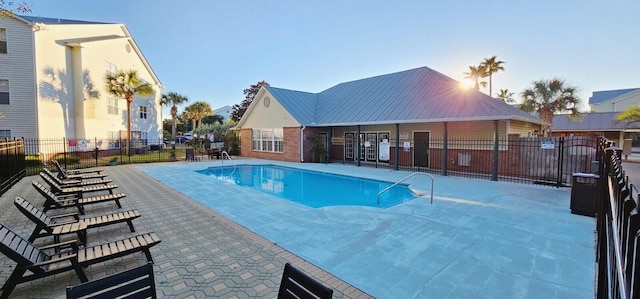 community pool featuring a patio area and fence