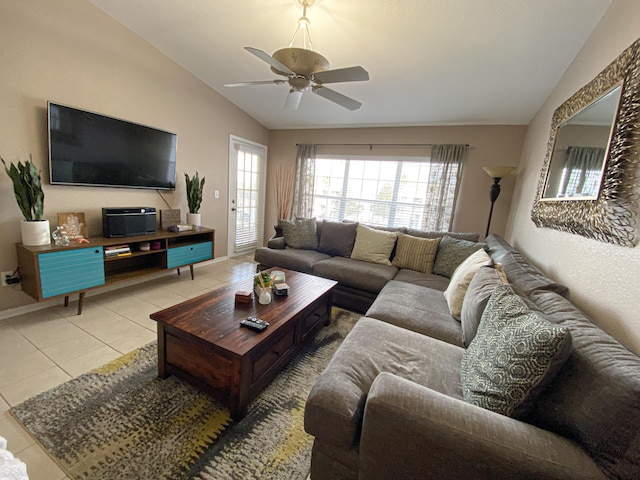 living room featuring light tile patterned floors, ceiling fan, vaulted ceiling, and a wealth of natural light