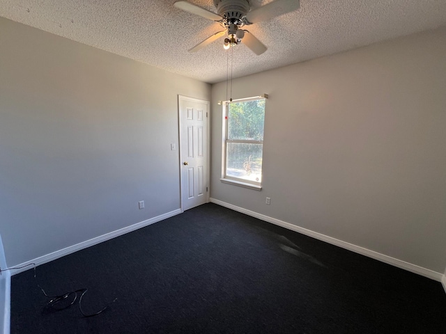 unfurnished room with dark colored carpet, a textured ceiling, and ceiling fan