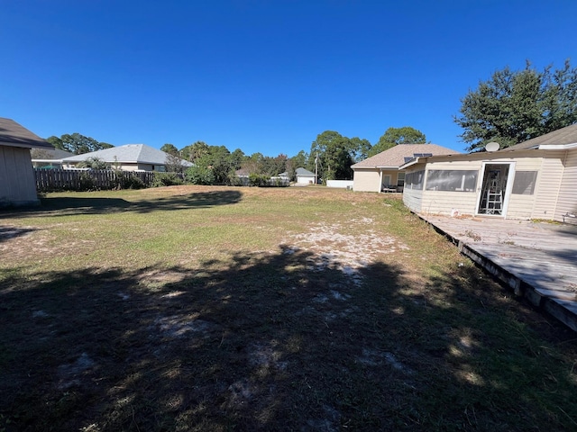 view of yard with a sunroom and a deck