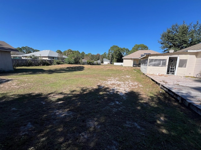 view of yard featuring fence and a wooden deck