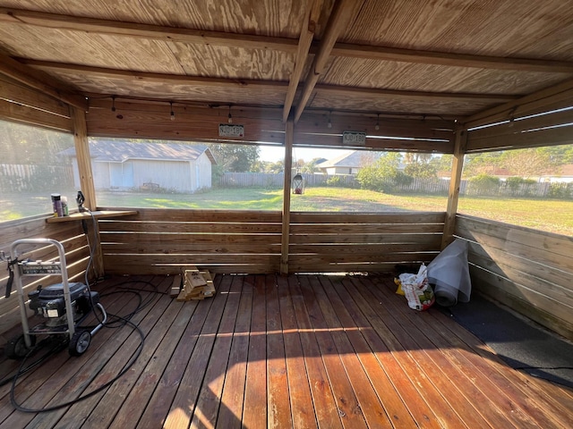 wooden terrace with a storage shed