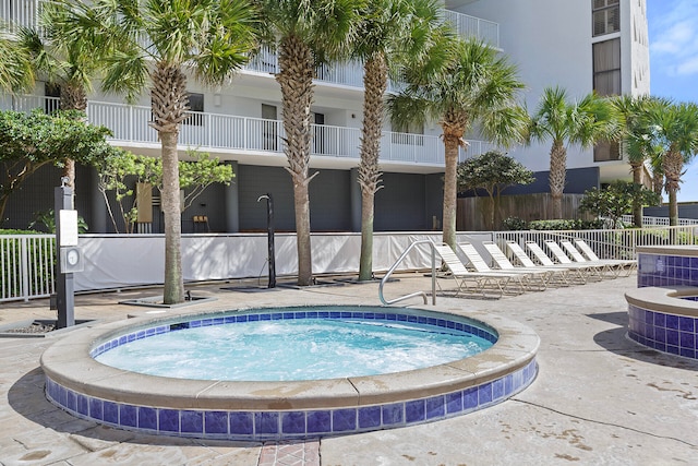 view of pool with a hot tub