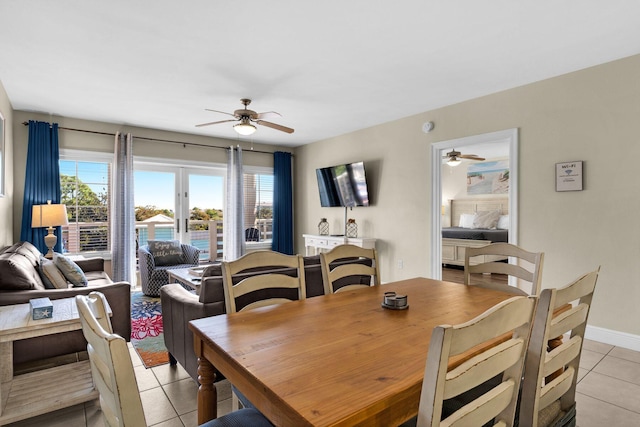 dining room featuring french doors, light tile patterned flooring, and ceiling fan