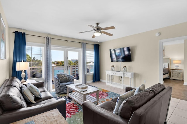 living room with ceiling fan, plenty of natural light, and light tile patterned floors