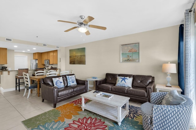 tiled living room featuring ceiling fan