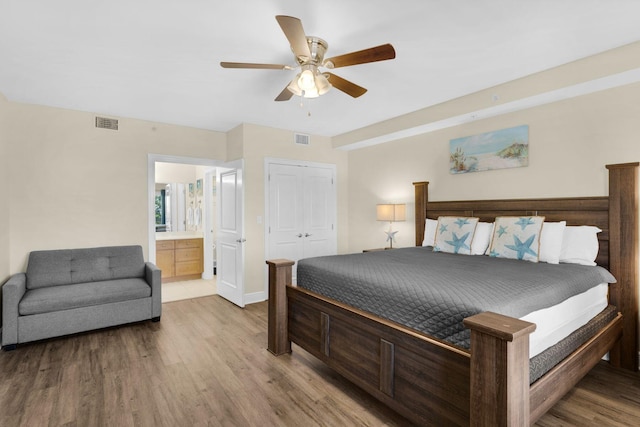 bedroom with connected bathroom, hardwood / wood-style floors, a closet, and ceiling fan