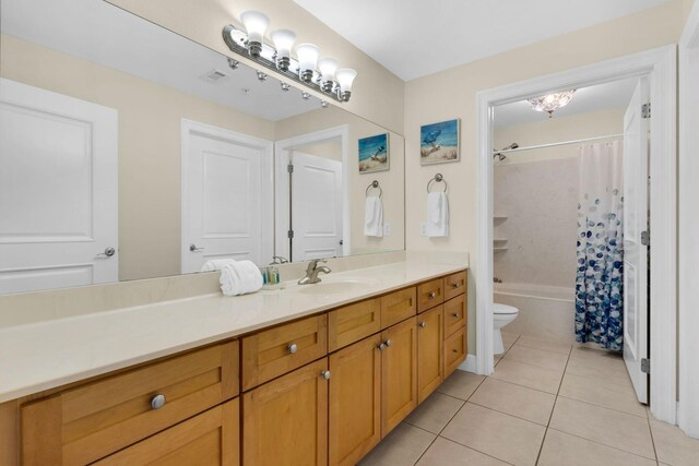 full bathroom featuring vanity, shower / bath combo with shower curtain, toilet, and tile patterned flooring