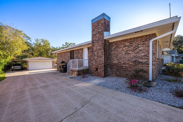 view of property exterior with a garage and an outbuilding