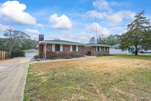 ranch-style home with brick siding, an outdoor structure, fence, a chimney, and a front yard