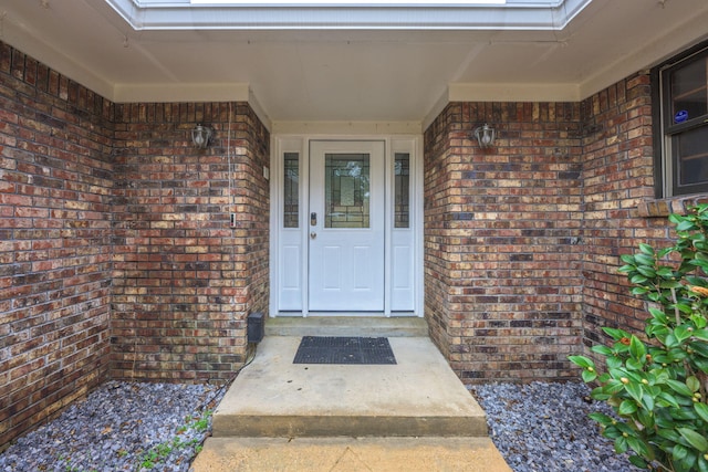 property entrance with brick siding