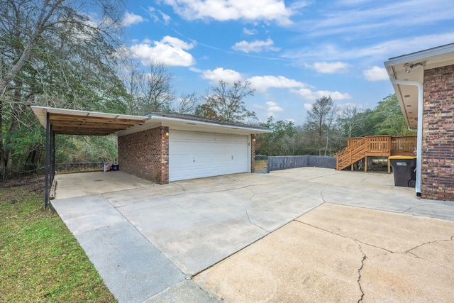 garage featuring a carport and concrete driveway