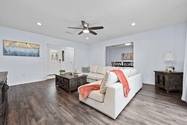 living room featuring recessed lighting, visible vents, baseboards, and wood finished floors