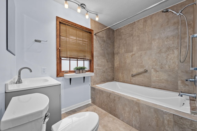 full bathroom featuring toilet, tiled shower / bath combo, tile patterned flooring, a textured ceiling, and vanity