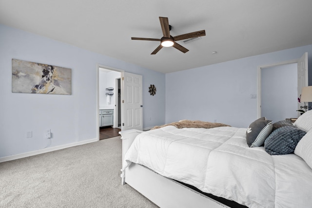 carpeted bedroom featuring ceiling fan, visible vents, baseboards, and ensuite bathroom