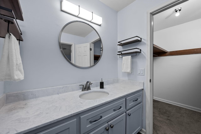 bathroom featuring vanity and baseboards