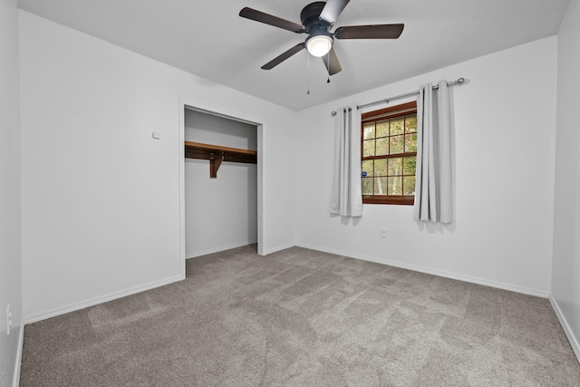 unfurnished bedroom featuring light carpet, a closet, a ceiling fan, and baseboards