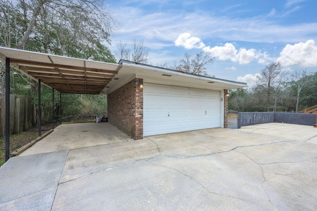 garage with fence and a carport