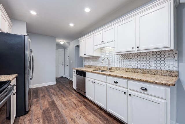 kitchen with light stone counters, sink, white cabinets, and appliances with stainless steel finishes