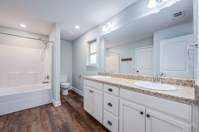 full bathroom featuring vanity, toilet, shower / bath combination, and hardwood / wood-style floors