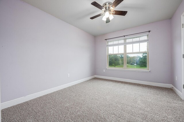 carpeted empty room featuring ceiling fan