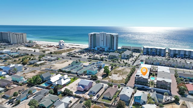 aerial view with a water view and a beach view