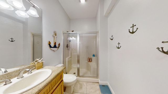 bathroom featuring a shower with door, toilet, tile patterned flooring, and vanity