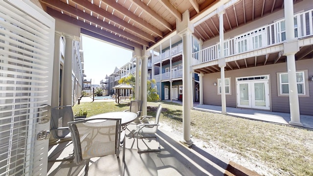 sunroom / solarium featuring beam ceiling and wooden ceiling