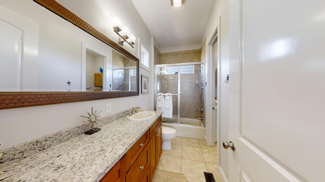 full bathroom with vanity, enclosed tub / shower combo, toilet, and tile patterned flooring