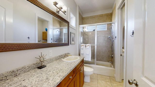 full bathroom with vanity, toilet, combined bath / shower with glass door, and tile patterned flooring