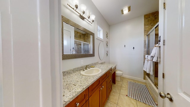 bathroom with vanity, toilet, walk in shower, and tile patterned flooring