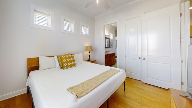 bedroom with connected bathroom, ceiling fan, crown molding, and light hardwood / wood-style flooring