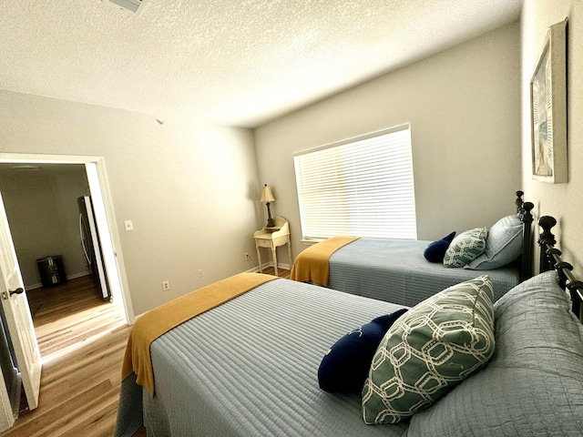 bedroom featuring hardwood / wood-style floors and a textured ceiling