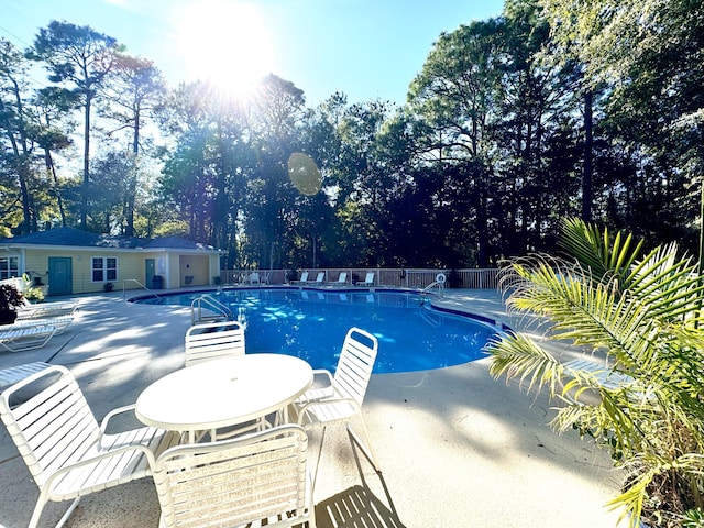200 Sandestin Ln Unit 1307, Miramar Beach, FL 32550 - community pool with a patio, fence, and view of wooded area