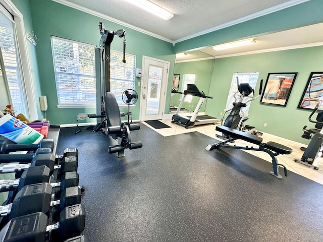 gym with ornamental molding and a textured ceiling